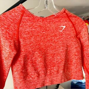Gymshark salmon colored long sleeve crop top